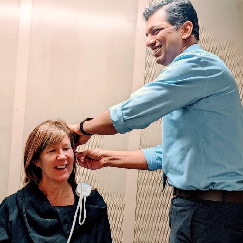 audiologist checking a patient's ear